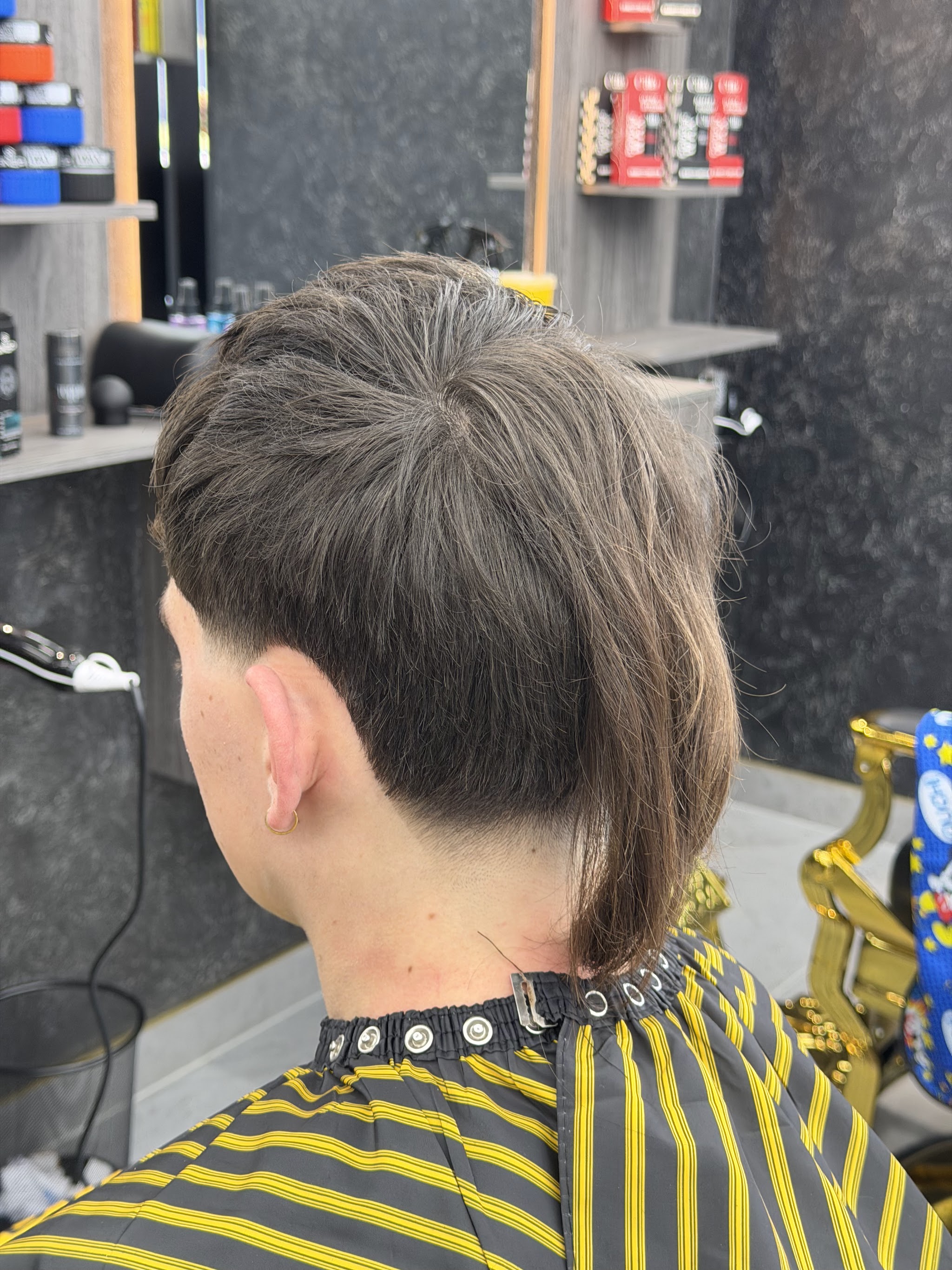 Back view of a finished cut: a tapered neckline with longer length through the back